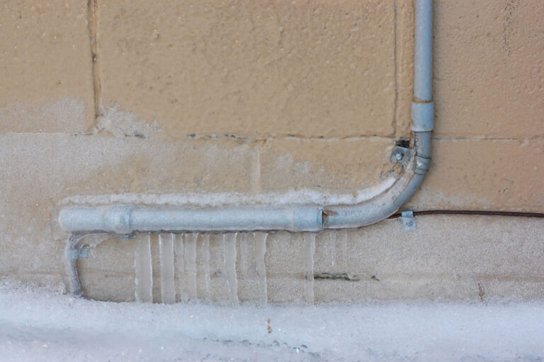 A frozen pipe against a wall.