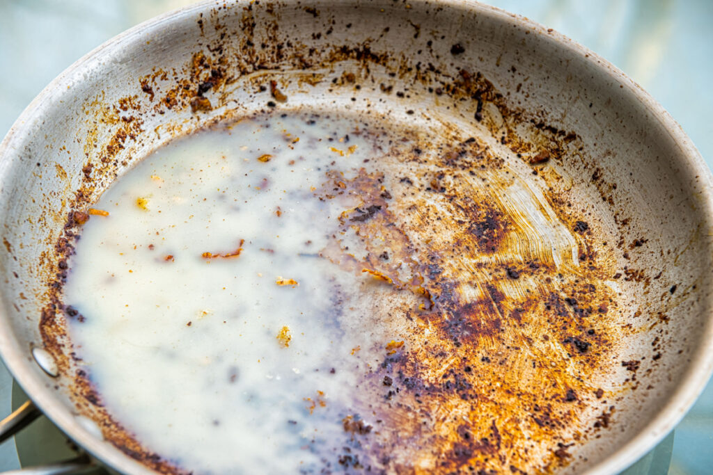 A close-up of a pan covered in cooking grease.